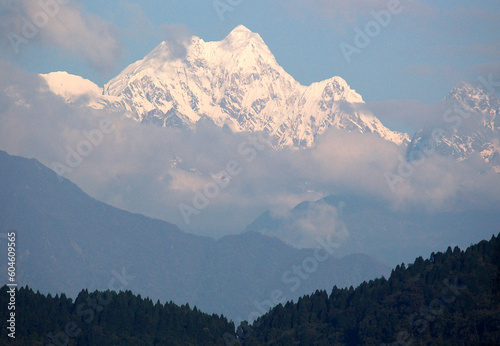 The magnificent view of fog covered Mt. Kangchenjunga, the third highest mountain in the world measuring situate at 8,586 m (28,169 ft) as seen from Gangtok, Sikkim.