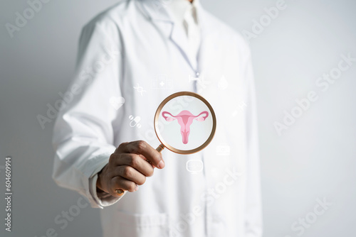 doctor in a white coat holding virtual uterus reproductive system , woman health, PCOS, ovary gynecologic and cervix cancer, Healthy feminine concept.. photo