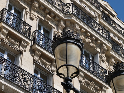 Parisian lamp post in front of facade