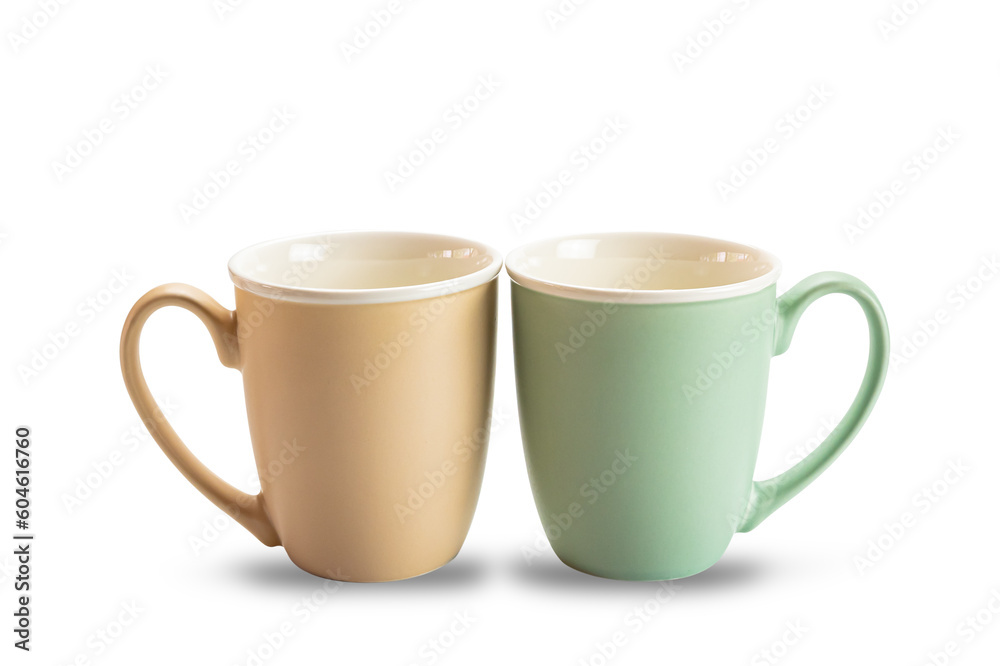 Side view of two empty ceramic coffee mugs brown and green isolated on white background with clipping path. Side view of two empty ceramic coffee mugs brown and green isolated on white background with clipping path.