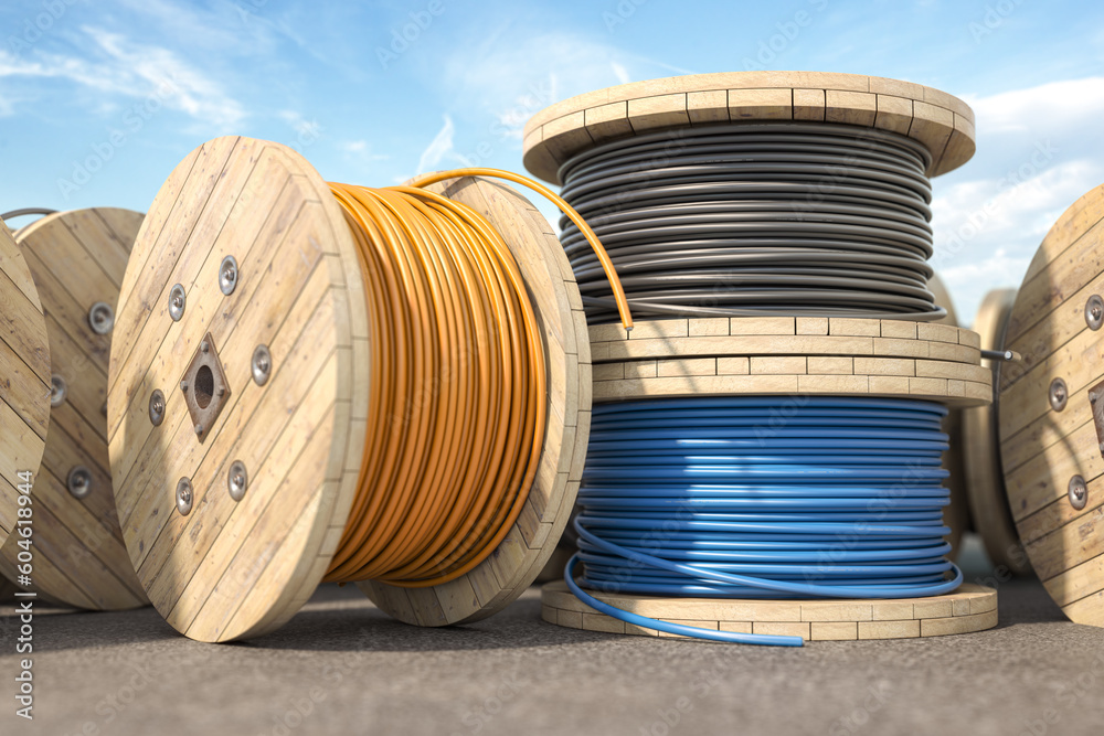 Wire electric cable of different colors on wooden coil or spool in warehouse. - obrazy, fototapety, plakaty 