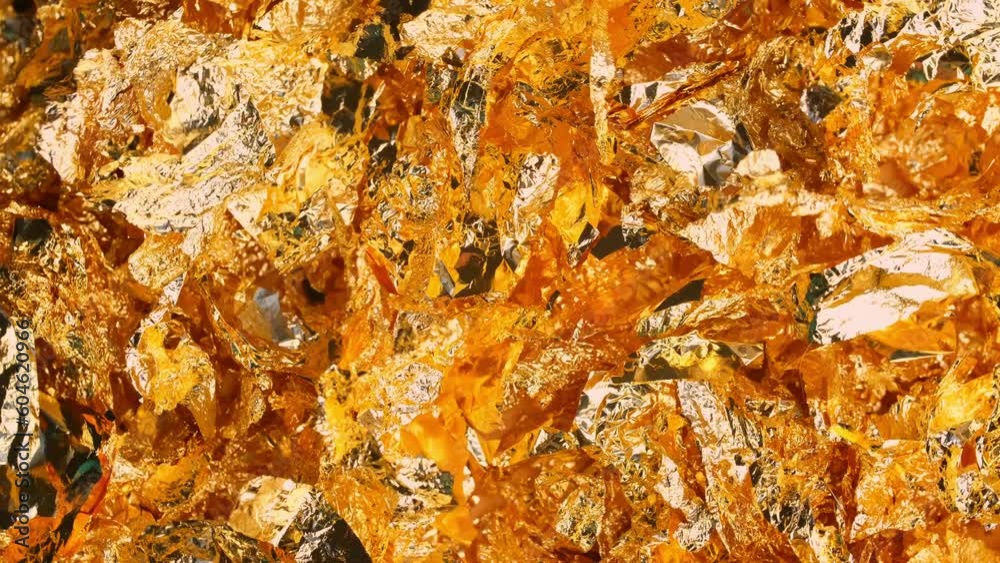 Golden texture background in slow motion. Golden potal close-up glitters and shimmers. Golden holiday background.