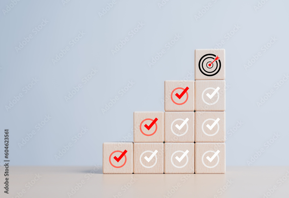 Checklist, Complete Task list. Goals achievement or enterprise objective target for company success. To do list. Check mark and dartboard from top of wooden cube stacks. Keys for success in business. Checklist, Complete Task list. Goals achievement or enterprise objective target for company success. To do list. Check mark and dartboard from top of wooden cube stacks. Keys for success in business.