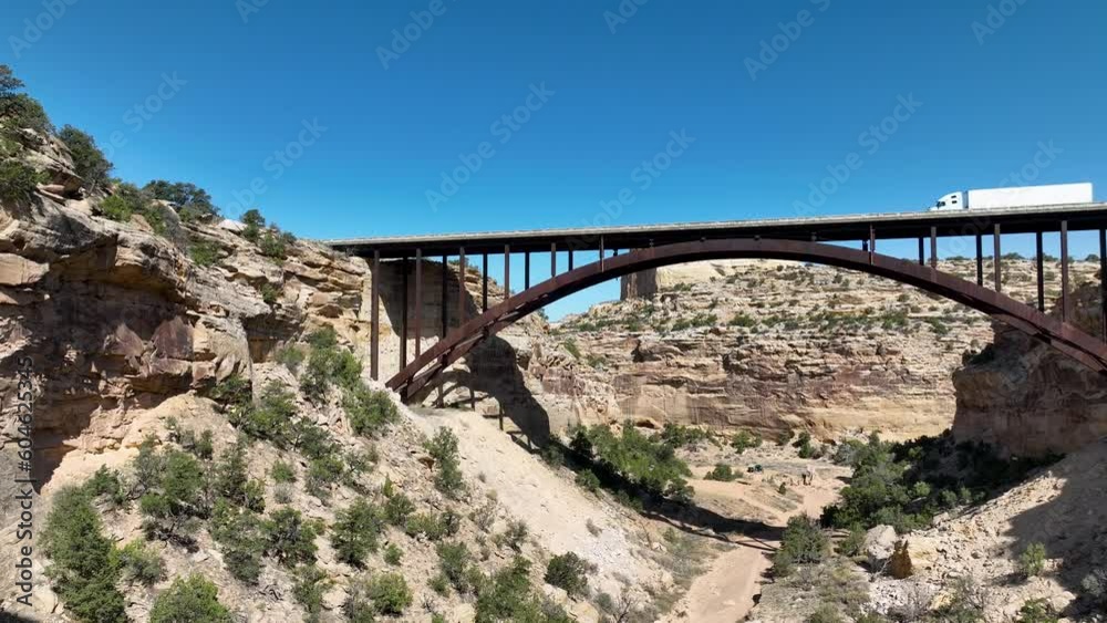 Aerial Eagle Canyon highway bridge fly under Utah 2. San Rafael Reef geologic landscape central Utah. Extreme recreation. Dangerous wilderness desert environment. Hikers, off road.