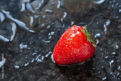 Ripe strawberries. Juicy ripe strawberries with water drops on a wet background. Red berries. Close-up. Brilliant glare. Selective focus