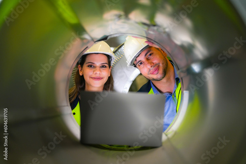 Fototapeta engineer wokers checking the steel tube with green working suite dress