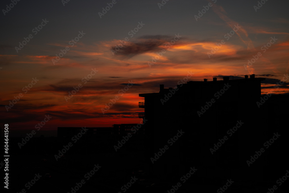 Sunset in the city with the silhouette of a building