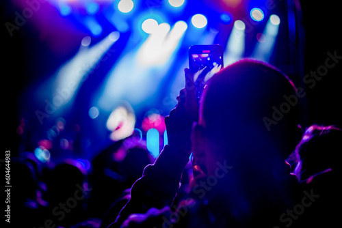 crowd of people dancing in a night life music concert