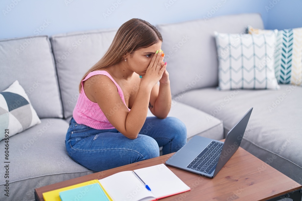 Young beautiful hispanic woman student sitting on sofa stressed at home Young beautiful hispanic woman student sitting on sofa stressed at home