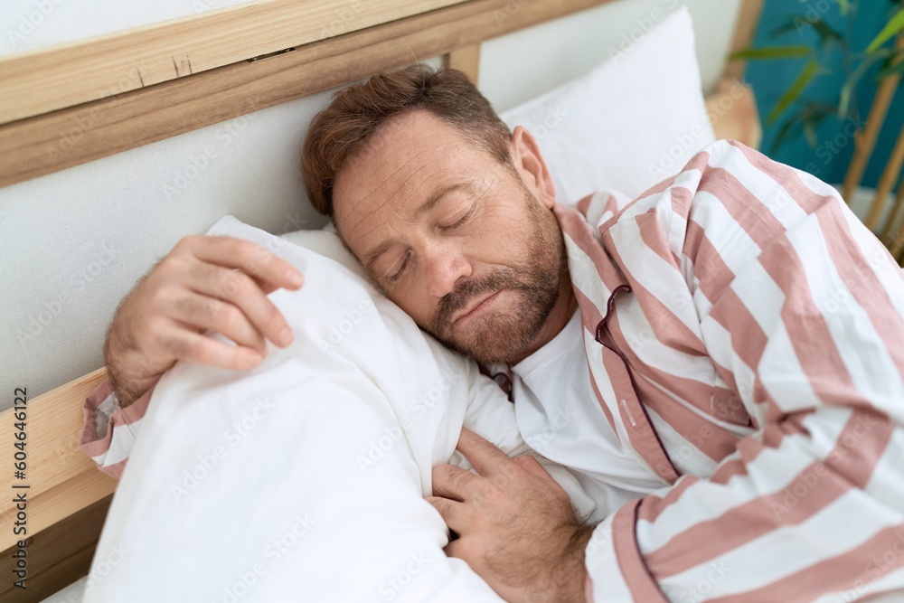 Middle age man lying on bed sleeping at bedroom Middle age man lying on bed sleeping at bedroom