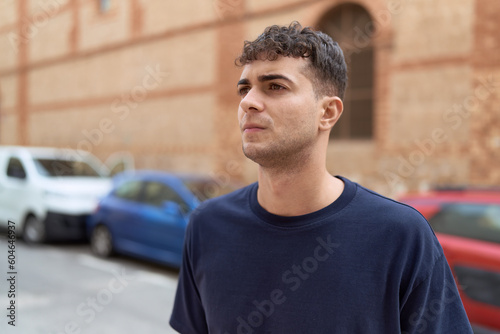 Young hispanic man looking to the side with serious expression at street © Krakenimages.com