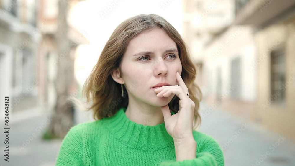 Young blonde woman standing with doubt expression at street Young blonde woman standing with doubt expression at street