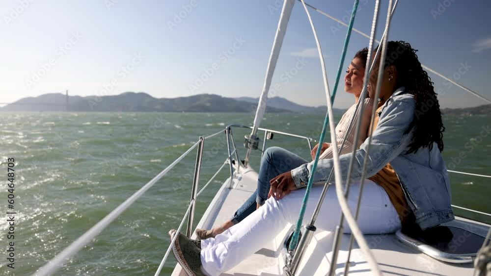Happy young gay lesbian couple sailing San Francisco Happy young gay lesbian couple sailing San Francisco