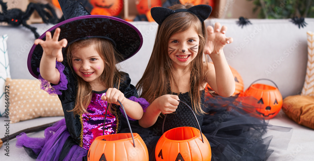 Adorable girls having halloween party doing fear gesture at home Adorable girls having halloween party doing fear gesture at home