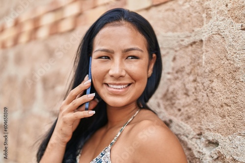 Young beautiful latin woman smiling confident talking on the smartphone at street