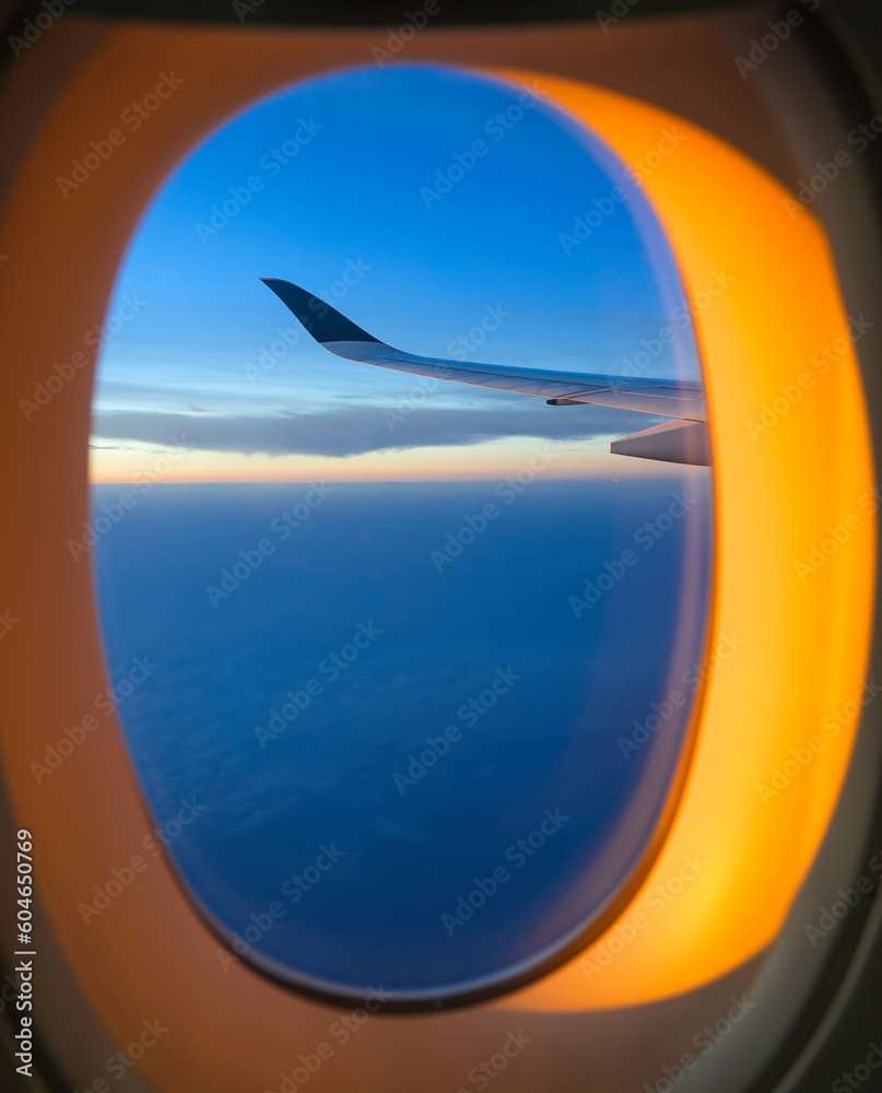 sunlight through airplane window from wing during sunrise sunlight through airplane window from wing during sunrise