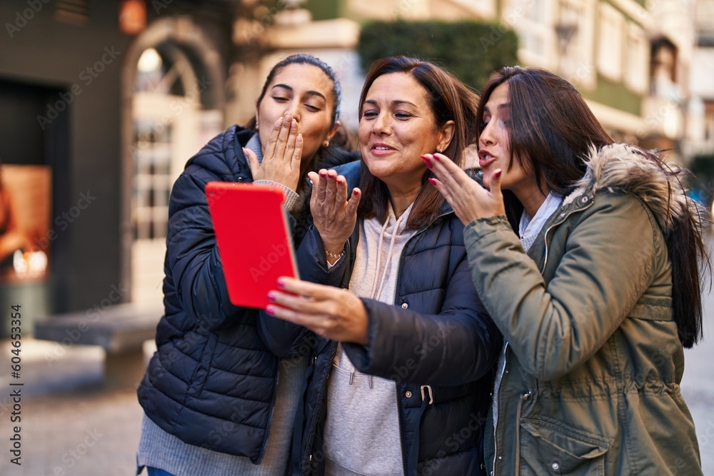 Three woman mother and daughters having video call at street Three woman mother and daughters having video call at street