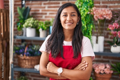 Young beautiful hispanic woman florist smiling confident standing with arms crossed gesture at flower shop © Krakenimages.com