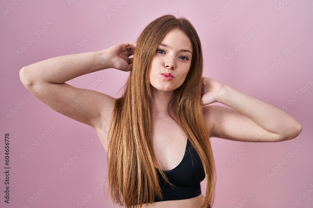 Young caucasian woman wearing lingerie over pink background looking at the camera blowing a kiss being lovely and sexy. love expression. Young caucasian woman wearing lingerie over pink background looking at the camera blowing a kiss being lovely and sexy. love expression.