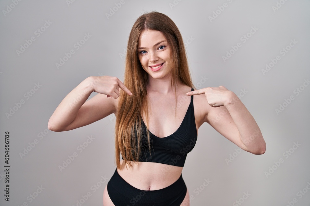 Young caucasian woman wearing lingerie looking confident with smile on face, pointing oneself with fingers proud and happy. Young caucasian woman wearing lingerie looking confident with smile on face, pointing oneself with fingers proud and happy.