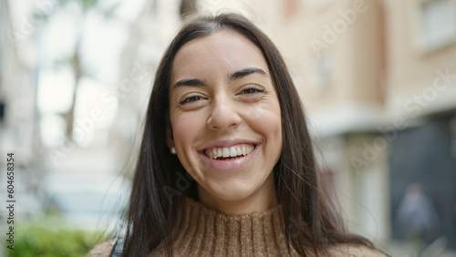 Young beautiful hispanic woman smiling confident standing at street © Krakenimages.com