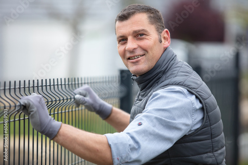 worker is fitting a fence