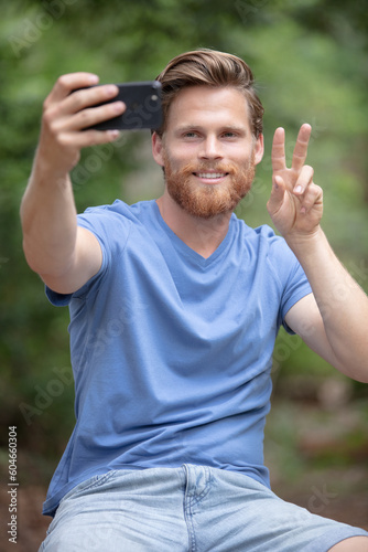 man in a wheelchair with hands up