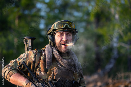 Close-up portrait of a smoking modern mercenary soldier.