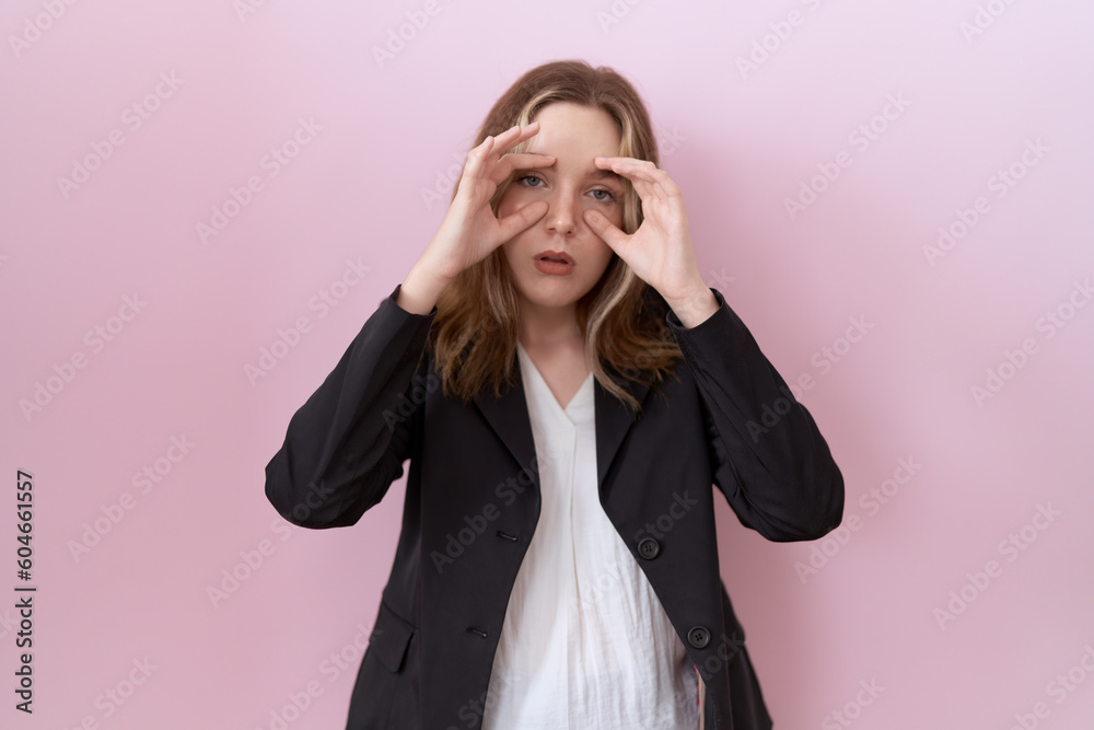 Young caucasian business woman wearing black jacket trying to open eyes with fingers, sleepy and tired for morning fatigue Young caucasian business woman wearing black jacket trying to open eyes with fingers, sleepy and tired for morning fatigue