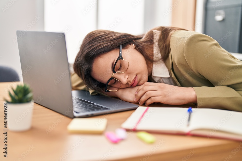 Young beautiful hispanic woman business worker leaning on laptop sleeping at office Young beautiful hispanic woman business worker leaning on laptop sleeping at office