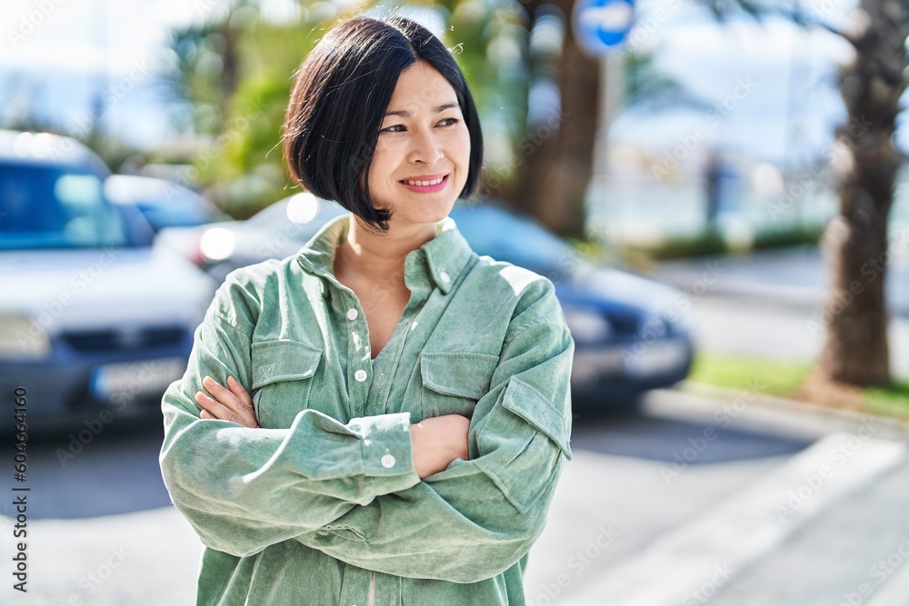 Young chinese woman smiling confident standing with arms crossed gesture at street Young chinese woman smiling confident standing with arms crossed gesture at street