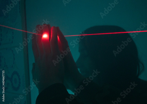 laser aiming a hand in the dark