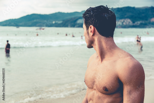 Handsome young man standing on a beach in Phuket Island, Thailand