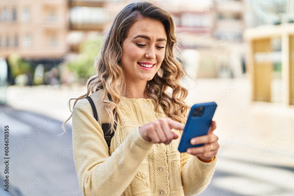 Young woman tourist smiling confident using smartphone at street Young woman tourist smiling confident using smartphone at street