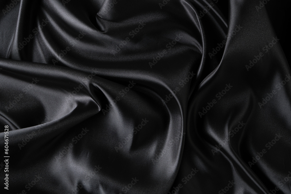 Silk fabric, abstract wavy black satin fabric background.