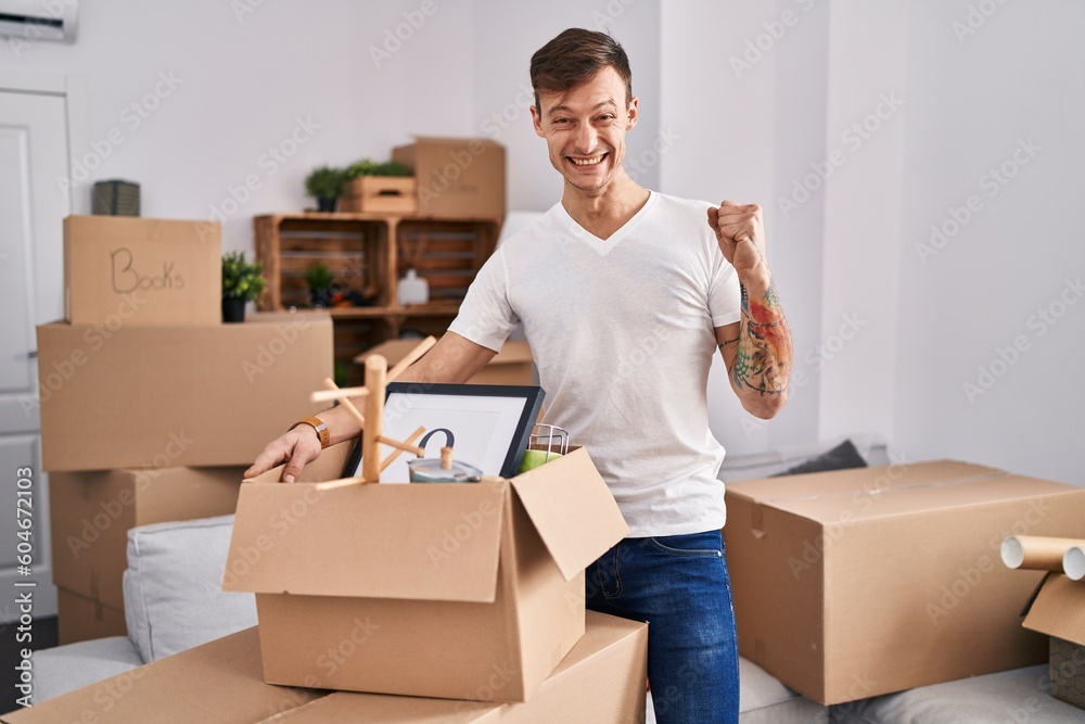 Caucasian man holding screwdriver at new home screaming proud, celebrating victory and success very excited with raised arms Caucasian man holding screwdriver at new home screaming proud, celebrating victory and success very excited with raised arms