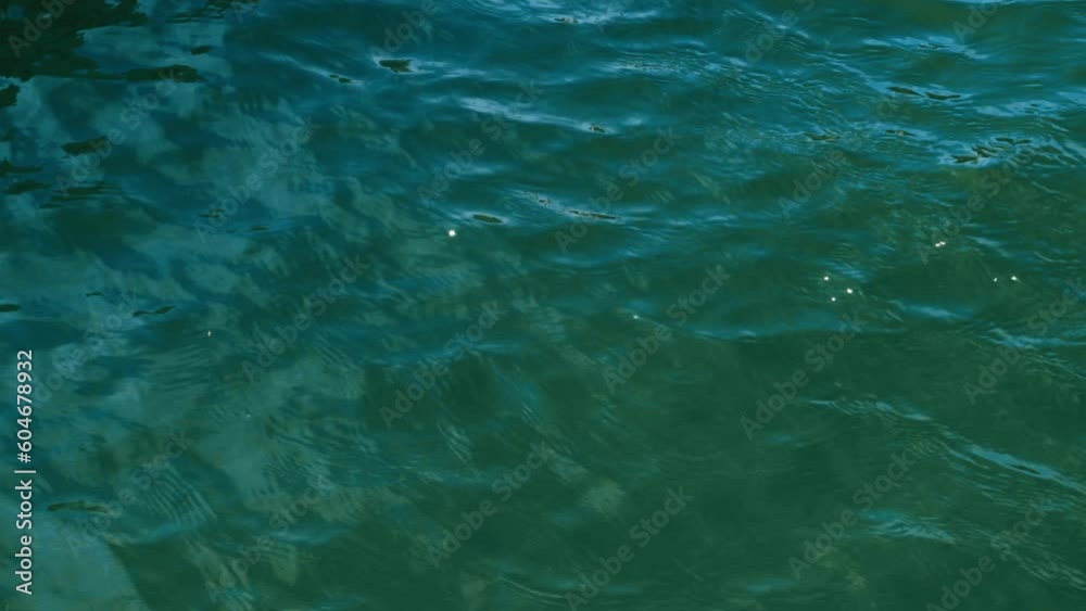 Ripples on the sea water. Close-up. Aqua, blue and green. 4K