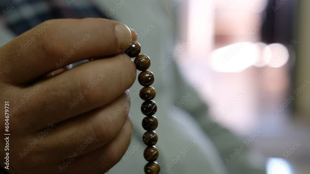 A Man Prays with the Rosary