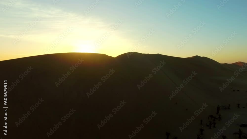 Sunset, silhouette and travel with drone of desert for freedom, adventure and discovery. Summer, nature and light on horizon in environment of sand dunes on trip with flare, sun and peace in Namibia Sunset, silhouette and travel with drone of desert for freedom, adventure and discovery. Summer, nature and light on horizon in environment of sand dunes on trip with flare, sun and peace in Namibia