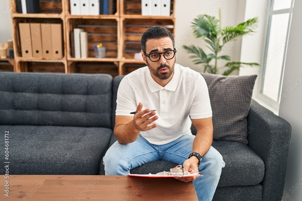 Young hispanic man psychologist having therapy session at psychology center