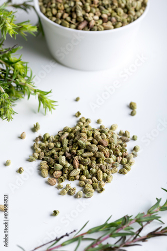 Bundle of fresh green aromatic thyme herbs with dried thyme seeds.