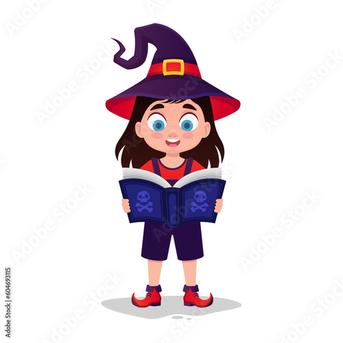 Cute child in witch costume reading a book
