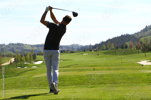 Man golfer on golf swing on golf course