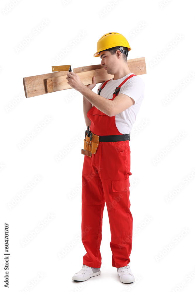 Young carpenter with wooden planks and ruler on white background Young carpenter with wooden planks and ruler on white background