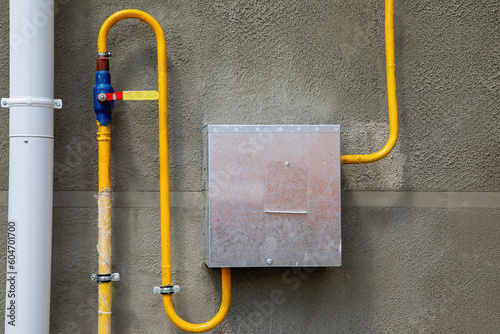 Gas distribution box with pipes on the wall of the house.