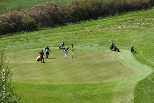 Four man on putting green
