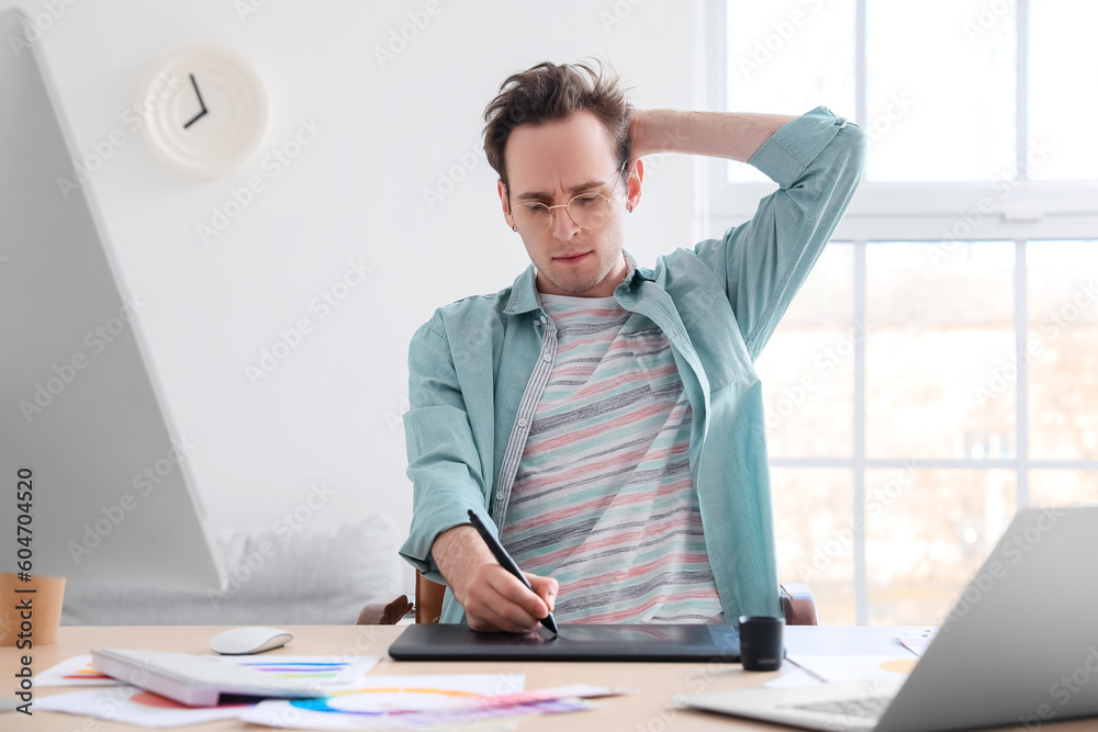 Male designer using graphic tablet in office Male designer using graphic tablet in office