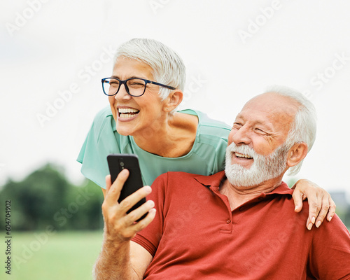 woman man outdoor senior couple happy lifestyle retirement together  love fun elderly active mobile smartphone communication phone