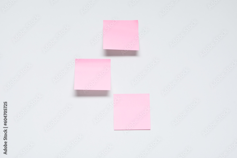 Pink sticky notes on grey background Pink sticky notes on grey background