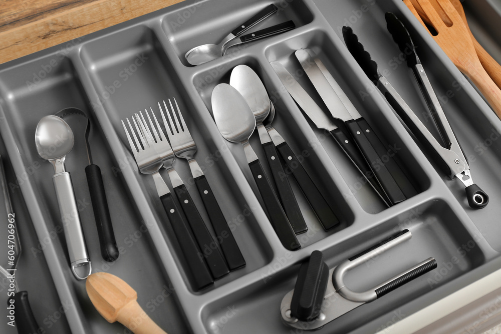 Open kitchen drawer with different silver cutlery Open kitchen drawer with different silver cutlery